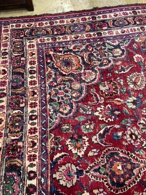A Heriz style burgundy ground carpet, 380 x 360cm